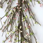 Green, white, and pink pip berry garland styled as primitive farmhouse home décor
