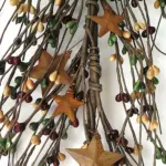 Mustard burgundy and green pip berry garland with rusty metal stars for primitive farmhouse and country home decor