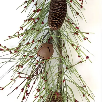 Christmas garland with green pine branches, red berries, pine cones, and jingle bells for rustic holiday decoration